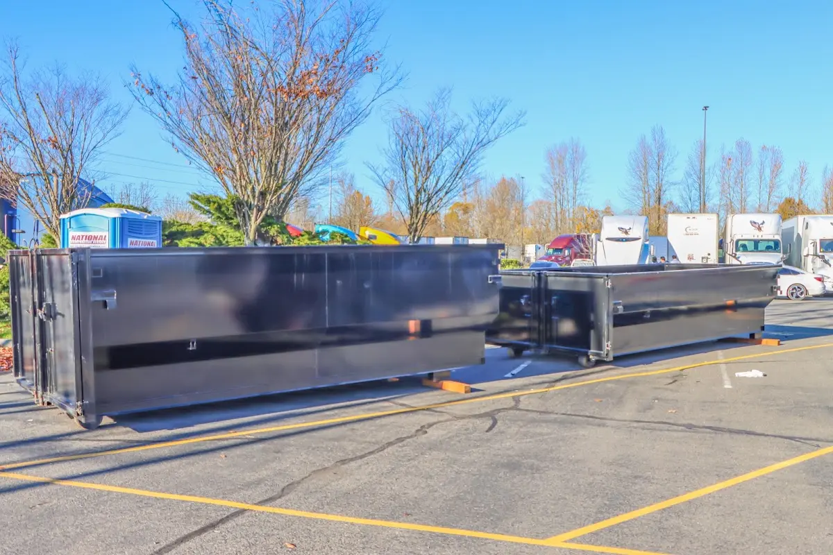 Professional dumpster rental service with roll-off container on residential driveway in River Vale